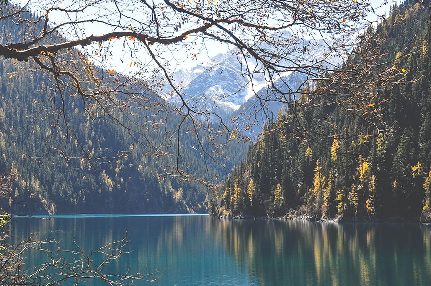 Autumn landscape of turquoise lake with mountains and trees