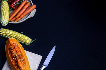 Fresh Vegetables and Knife on Dark Background