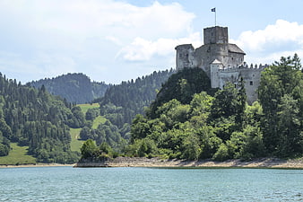 Orava Castle on a Hill Overlooking a Lake in Summer