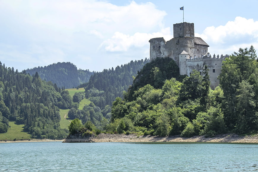 Orava Castle on a Hill Overlooking a Lake in Summer