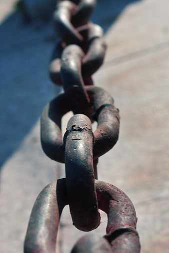 Close-up of rusty iron chain links outdoors