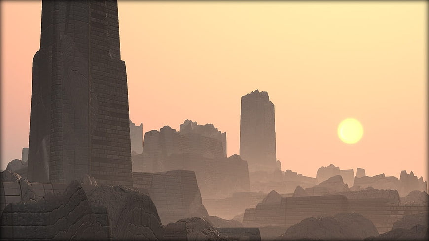 Ancient Stone Ruins Silhouetted Against Hazy Orange Sunset Sky