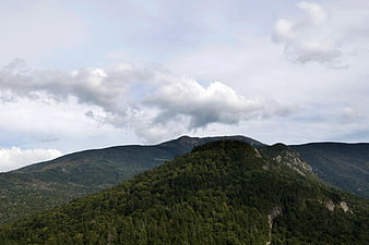 Aerial View of Green Mountain Ridge Under Cloudy Sky