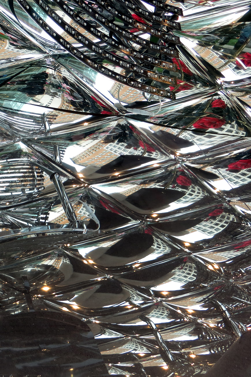 Abstract chrome diamond pattern with distorted city reflections