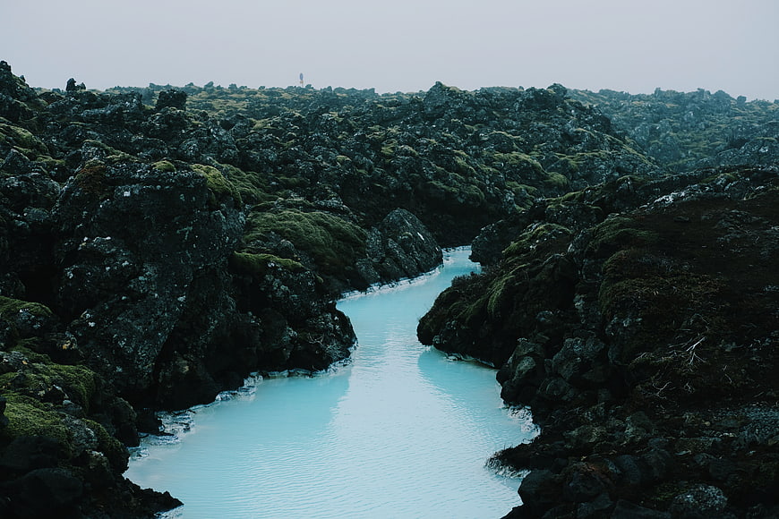 Turquoise River Flowing Through Mossy Lava Rocks