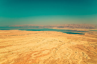 Aerial View of Desert Landscape with Turquoise Water and Mountains