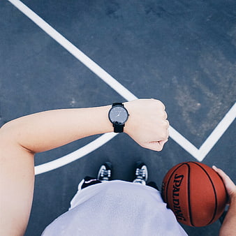 First-person view of basketball player checking watch on court