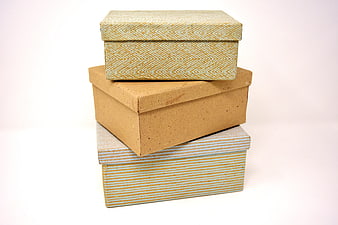Stacked Kraft and Patterned Cardboard Storage Boxes on White Background