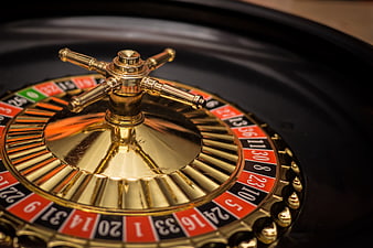 Close-up of a golden roulette wheel in a casino