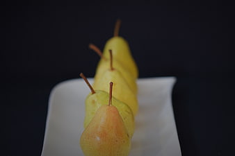 Fresh yellow pears arranged on a white rectangular plate