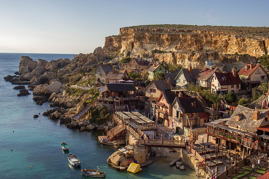 Popeye Village coastal village in Malta with boats and cliffs