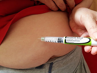 Close-up of insulin injection into stomach for diabetes management
