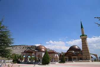 Modern Mosque with Minaret and Domes Under Blue Sky