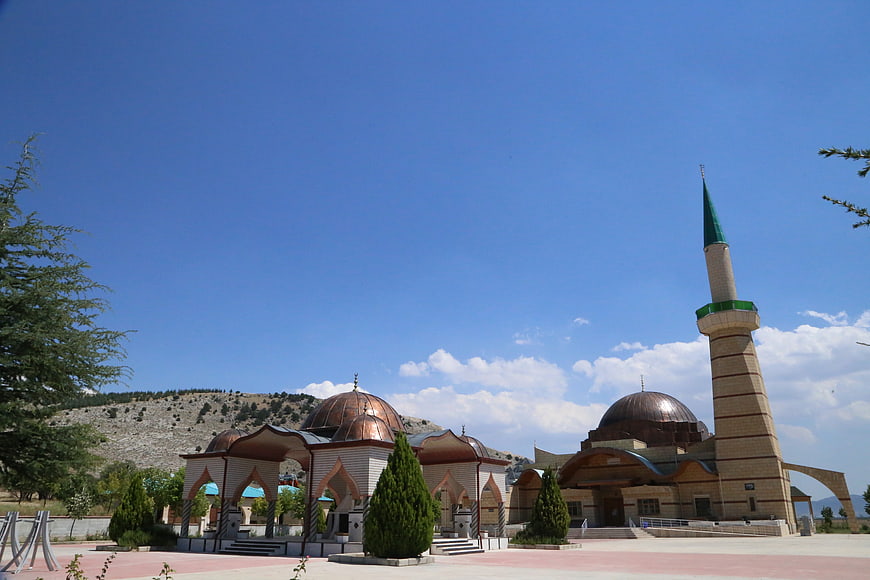 Modern Mosque with Minaret and Domes Under Blue Sky