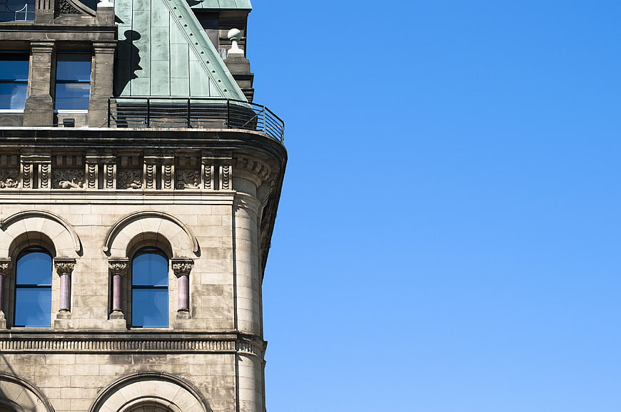 Historic Building Corner with Arched Windows and Blue Sky