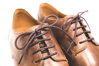 Close-up of brown leather men's shoes on white background