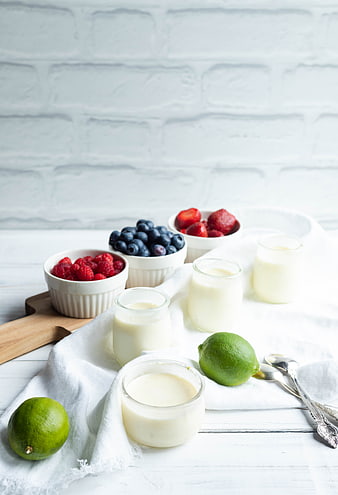 Homemade lime panna cotta with fresh berries and limes