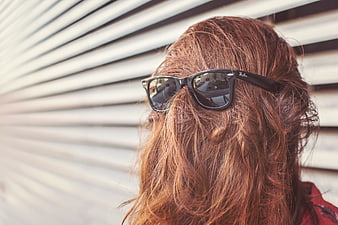 Woman with Red Hair Wearing Black Sunglasses