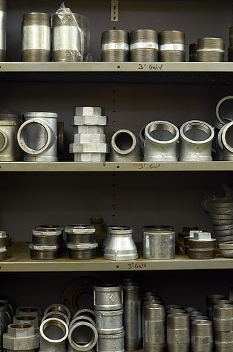 Shelves of galvanized steel pipe fittings and hardware