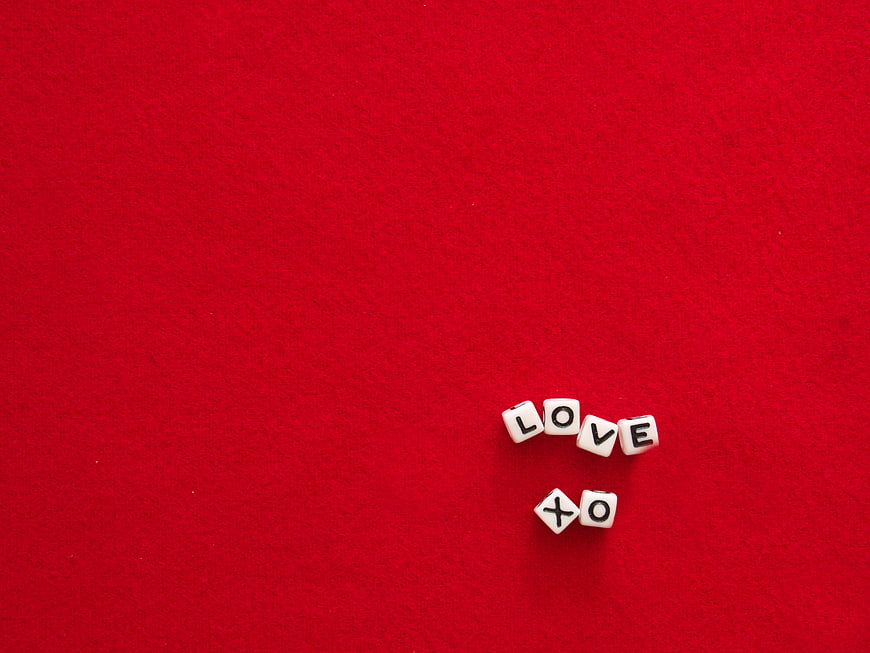 White Dice Spelling Love XO on Red Background