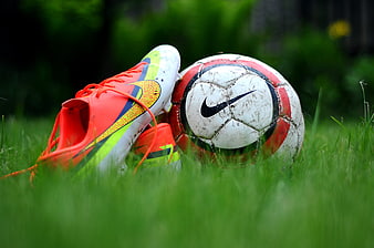 Nike Soccer Cleats and Ball on Green Grass