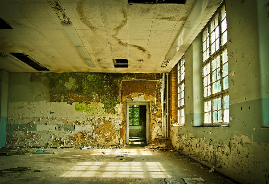 Abandoned Dilapidated Room with Peeling Paint and Sunlight