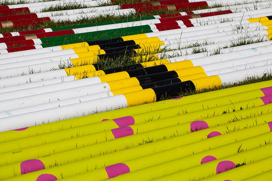 Colorful Horse Jump Poles on Grass