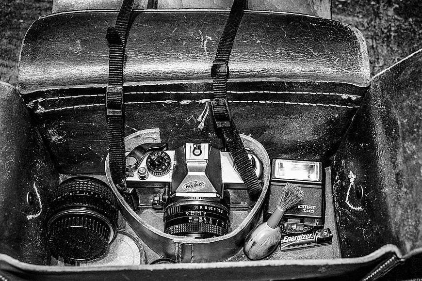 Vintage film camera gear in worn leather case
