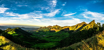 Panoramic Green Mountain Landscape with Blue Sky and Clouds