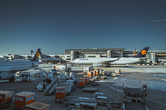 Lufthansa airplanes at busy airport terminal tarmac