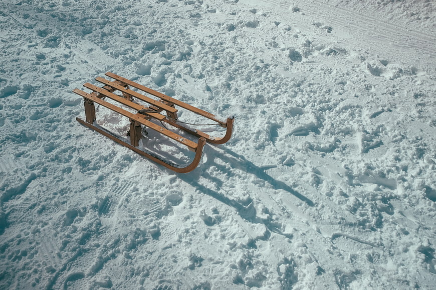 Wooden Sled on Snowy Winter Landscape