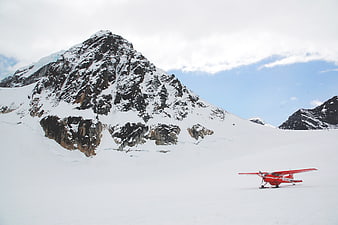 Red Ski Plane on Snowy Mountain Glacier Landscape