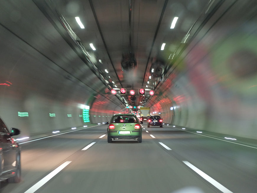 Motion blur view of cars driving through a busy highway tunnel