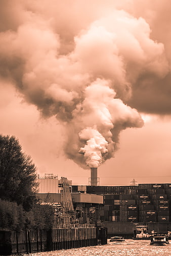 Industrial Smoke Plume Rising Over Container Port in Sepia Tone