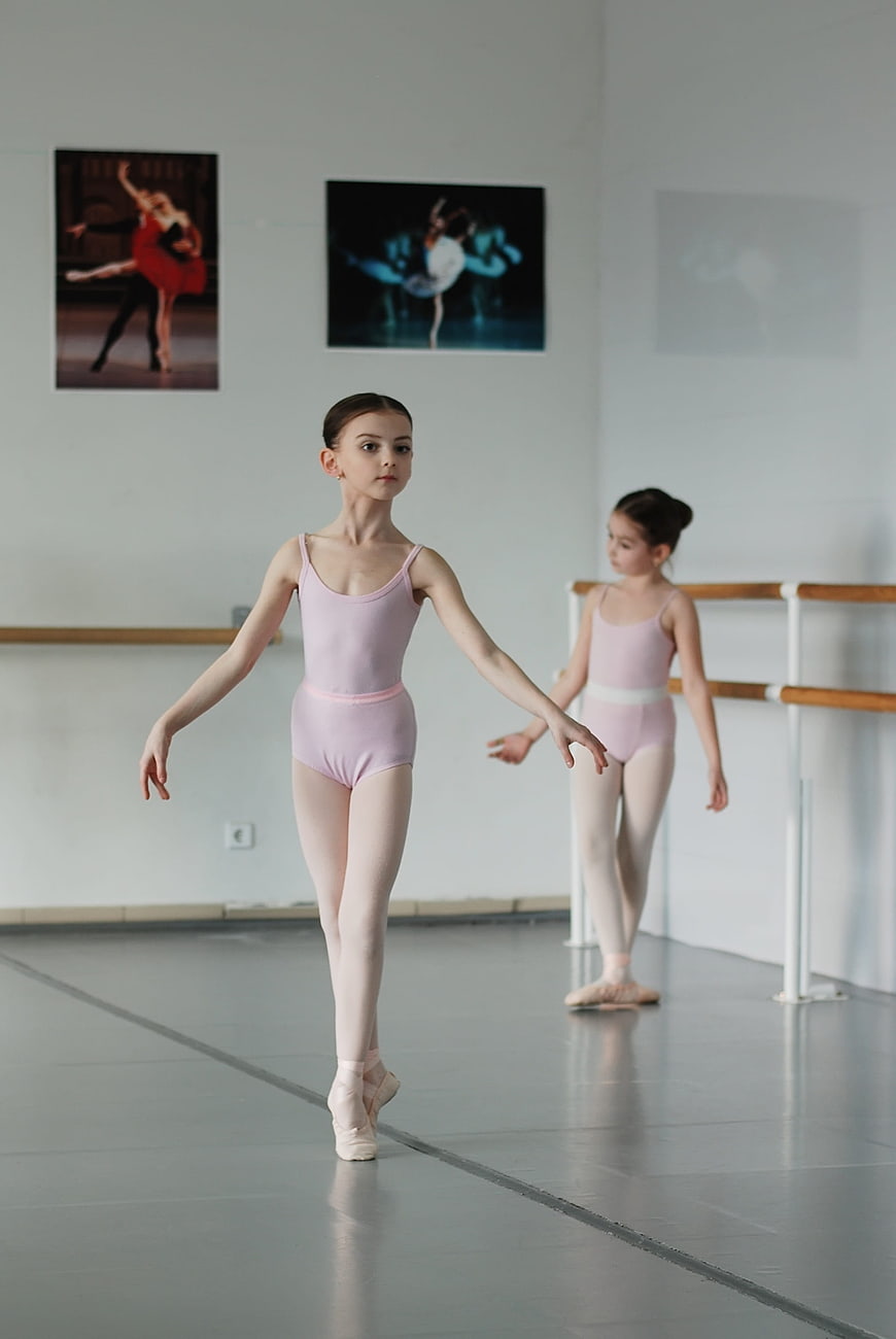 Young ballerina practicing ballet in dance studio