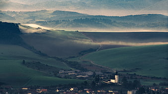 Misty Morning Landscape with Rolling Hills and Village Church