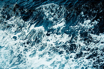 Aerial View of Turbulent Blue Ocean Waves and White Sea Foam