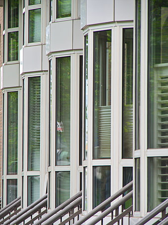 Modern building facade with geometric windows and railings