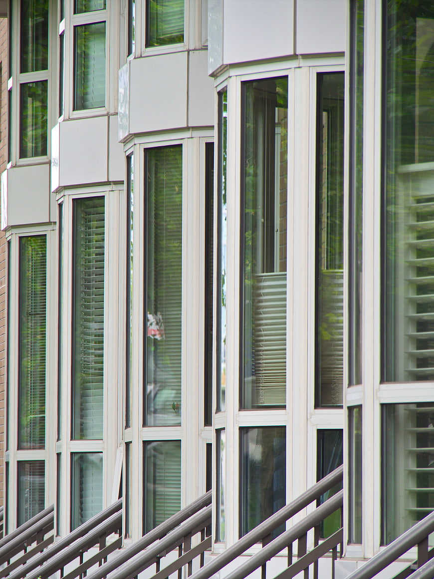 Modern building facade with geometric windows and railings