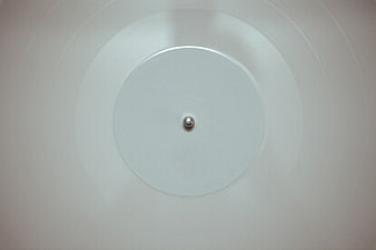 Minimalist white vinyl record with silver spindle