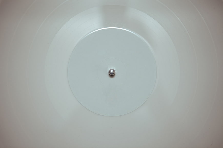 Minimalist white vinyl record with silver spindle