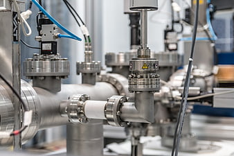 Close-up of industrial stainless steel pipes and valves in a factory