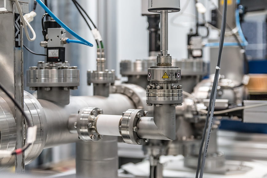 Close-up of industrial stainless steel pipes and valves in a factory