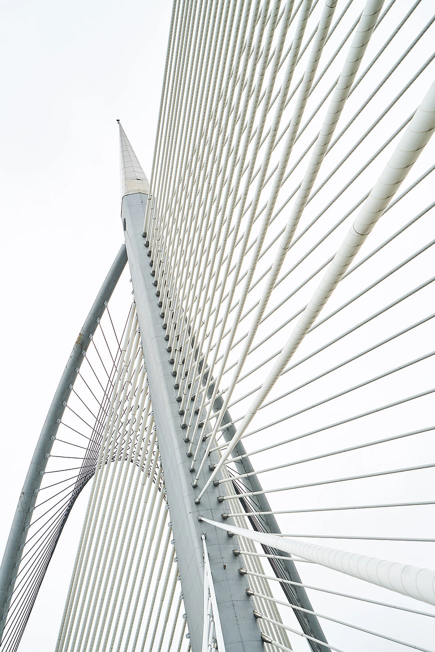 Low angle view of white cable-stayed bridge tower