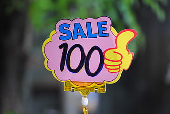 Hand-painted pink sale sign with 100 discount and thumbs up