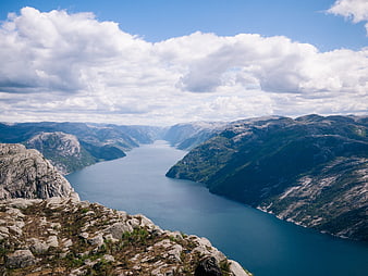 Scenic View of a Norwegian Fjord with Rocky Mountains and Clouds