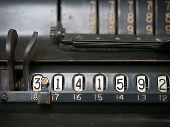 Close-up of vintage mechanical calculator with number dials