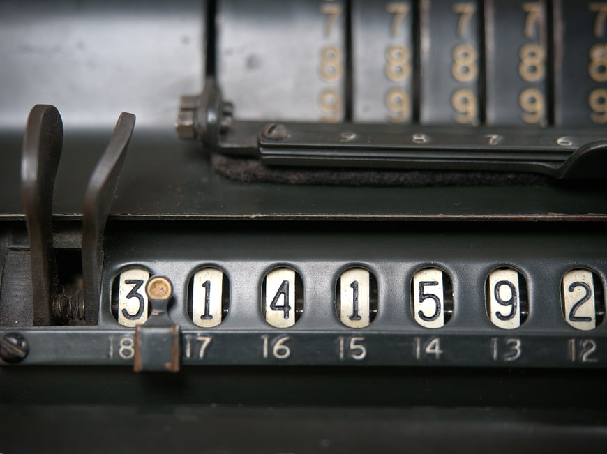 Close-up of vintage mechanical calculator with number dials