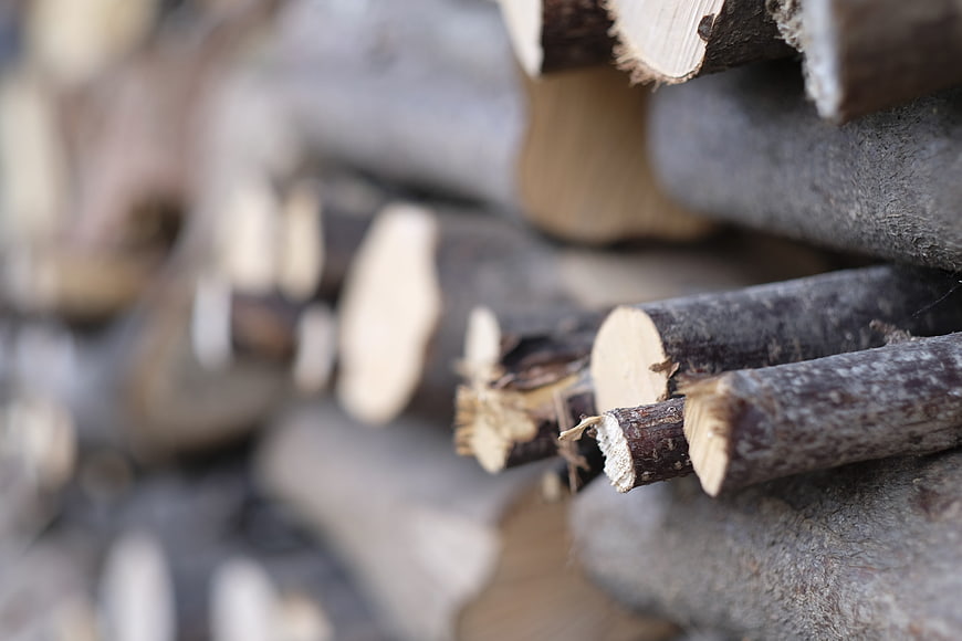Close-up of stacked firewood logs with shallow depth of field