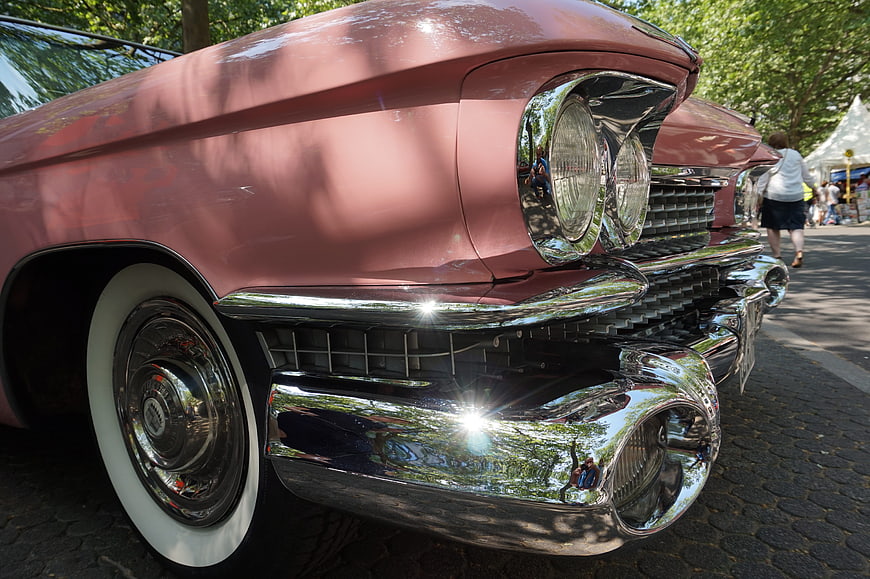 Close-up of vintage pink classic car with chrome details